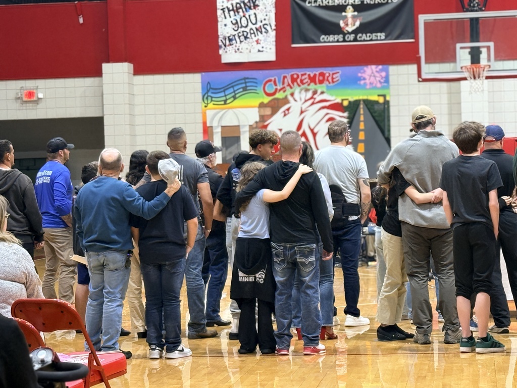 WRJH Students hugging loved ones at the end of their veterans day service