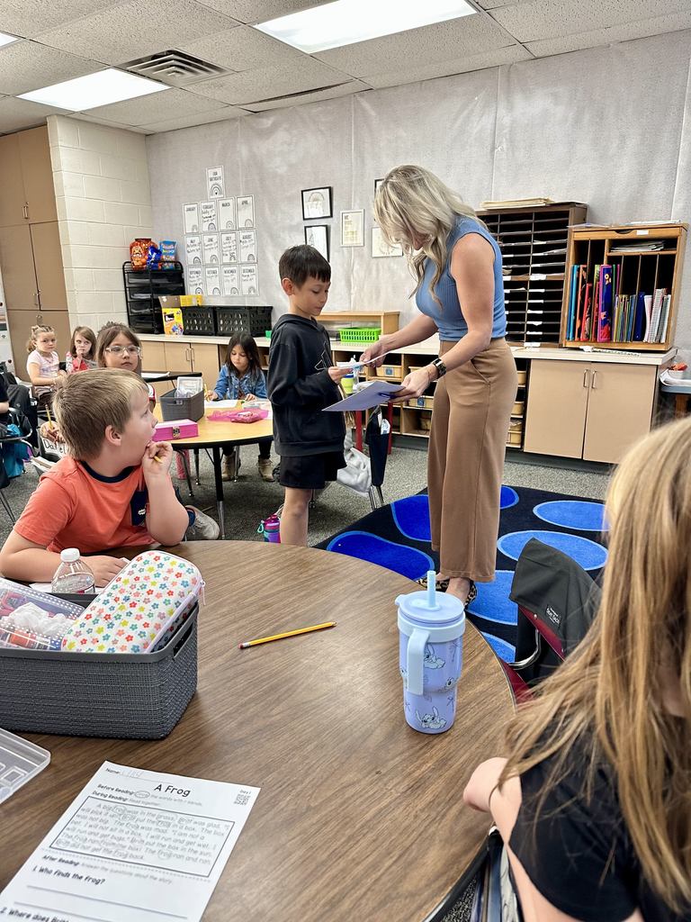 student handing principal kindness paper