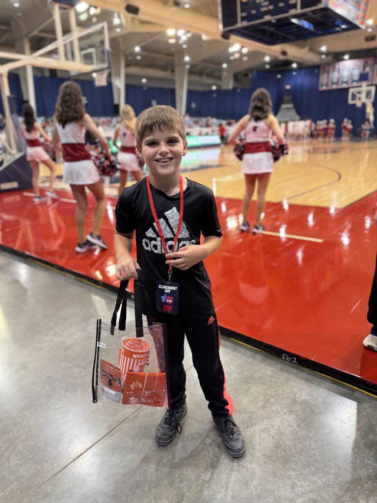 student smiling at RSU game with prize