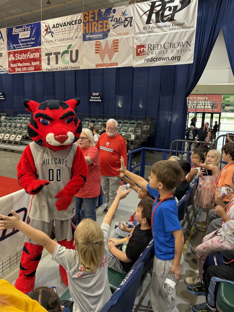 student smiling at RSU game with Hillcat