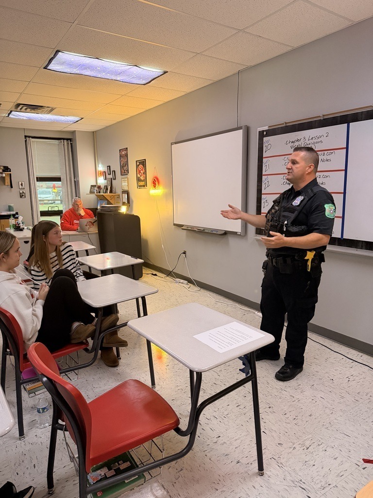 Officer Holmes talking to Junior High Students.