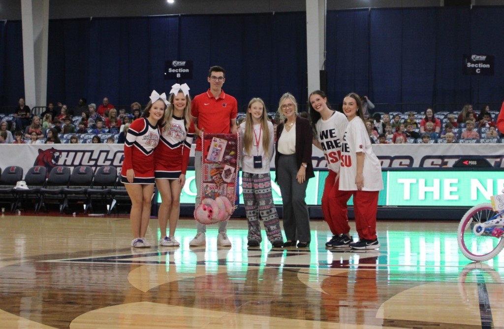 students smiling at RSU game