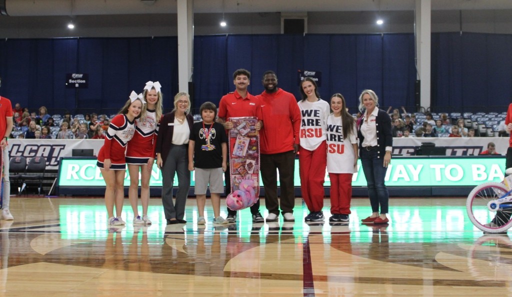 students smiling at RSU game