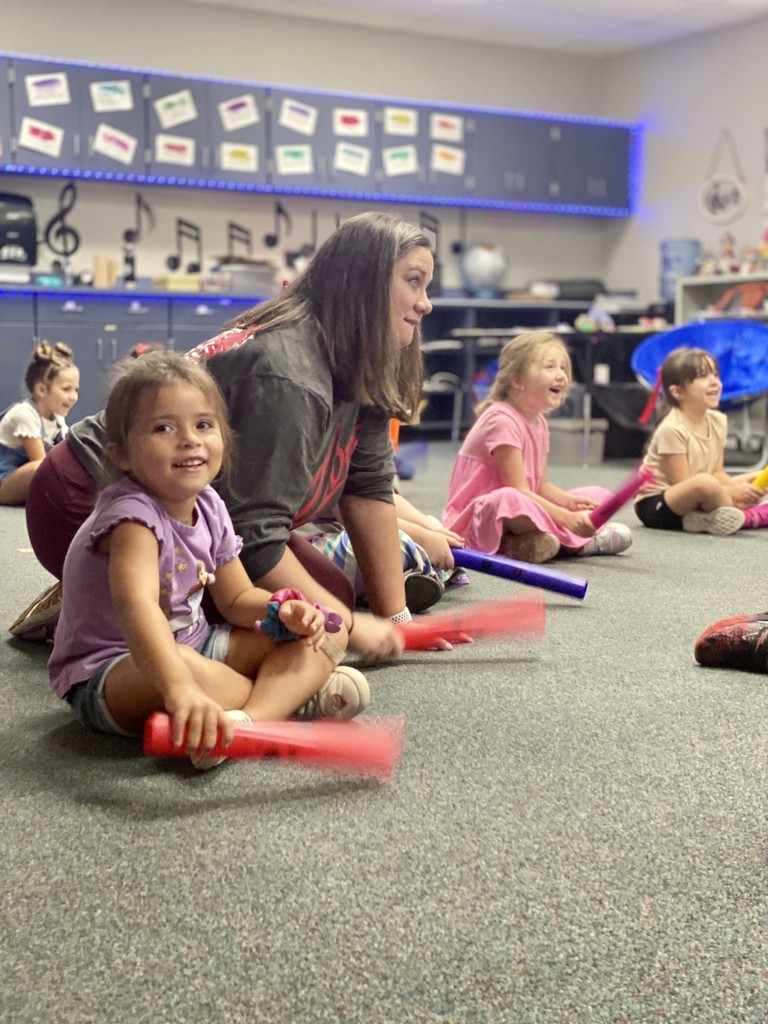 Students smiling and having fun in their music class