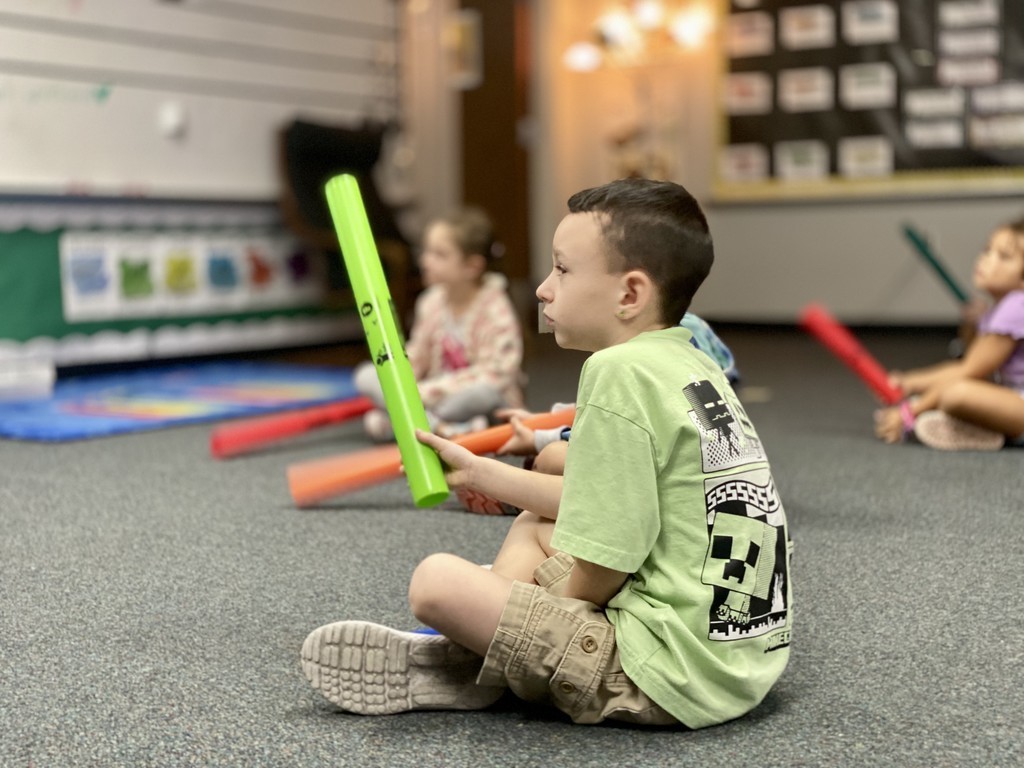 Student in green shirt in music class