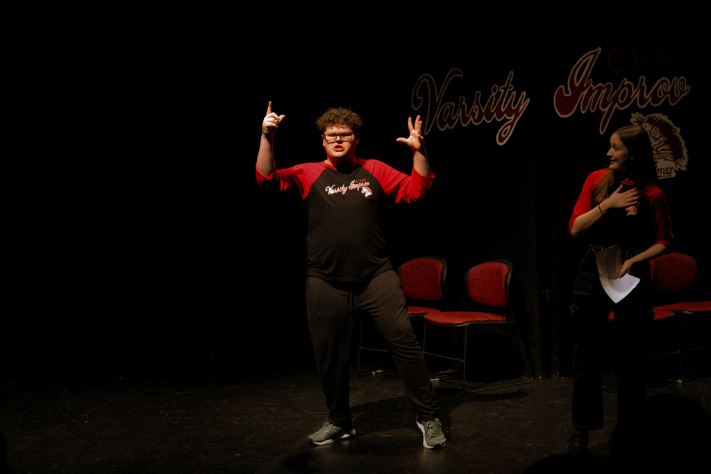 Student with hands in the air during an improv game 