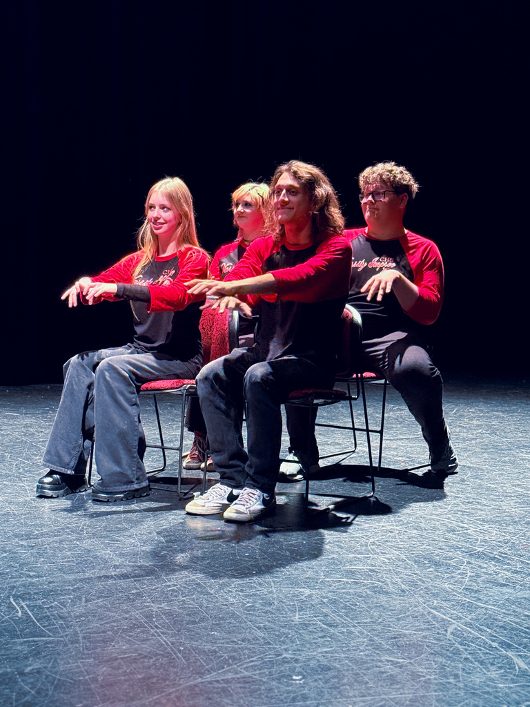 Students pretending to be at work while they improv what they are doing at work