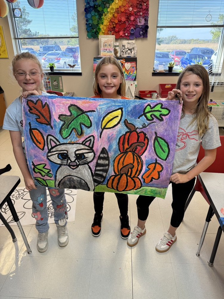 Students holding their finished art work.