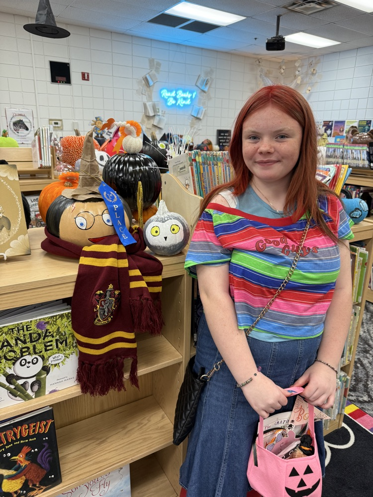 student with their pumpkin