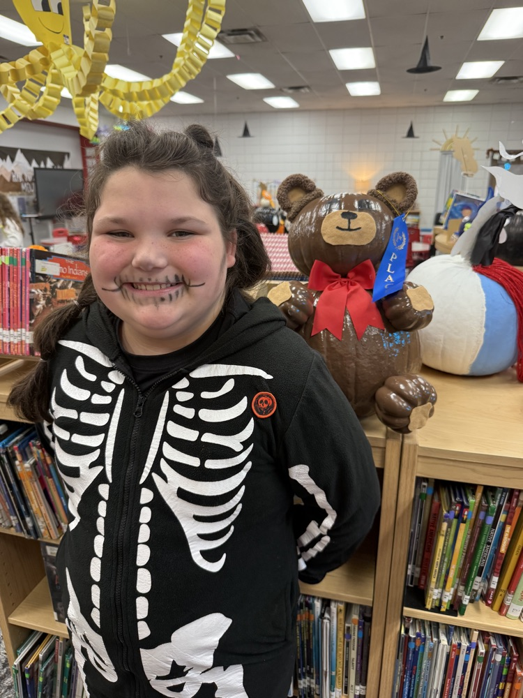 student with their pumpkin student with their pumpkin