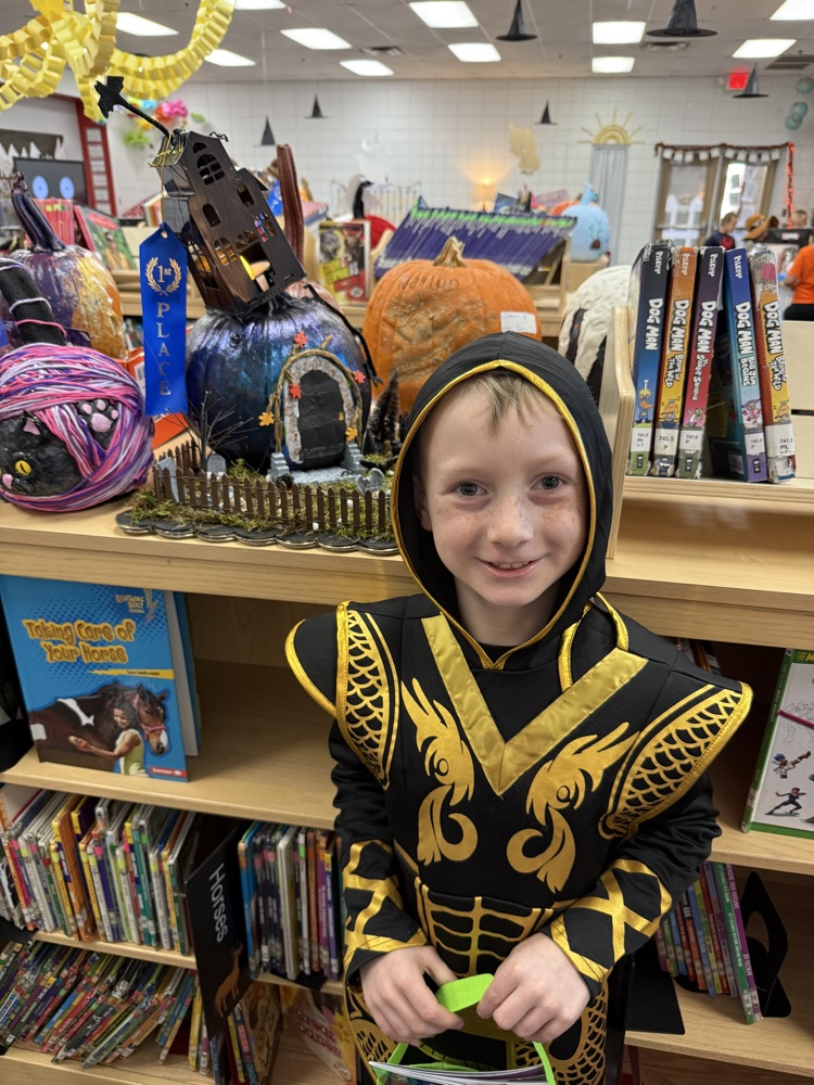 student with their pumpkin
