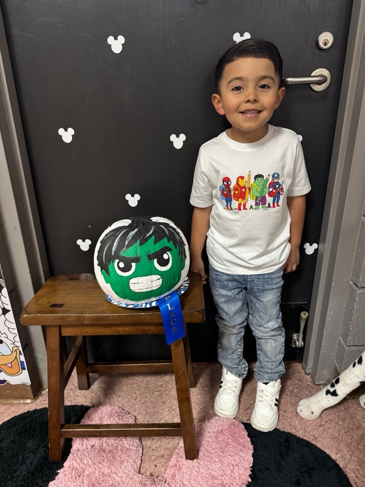student with their pumpkin