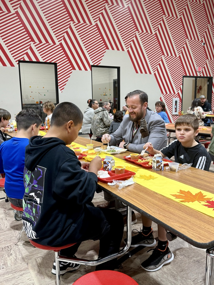 teacher and students eating Thanksgiving meal