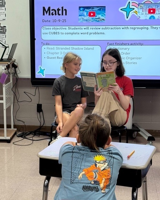 kids reading in front of class