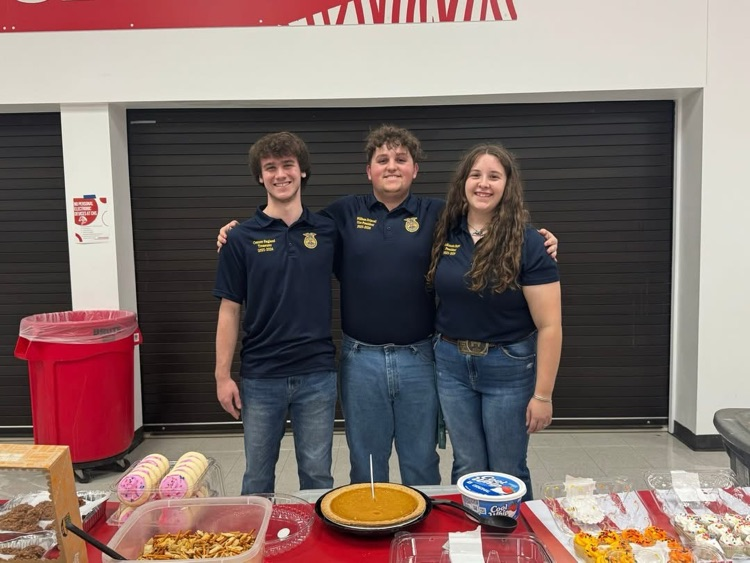 FFA officers in front of food tables