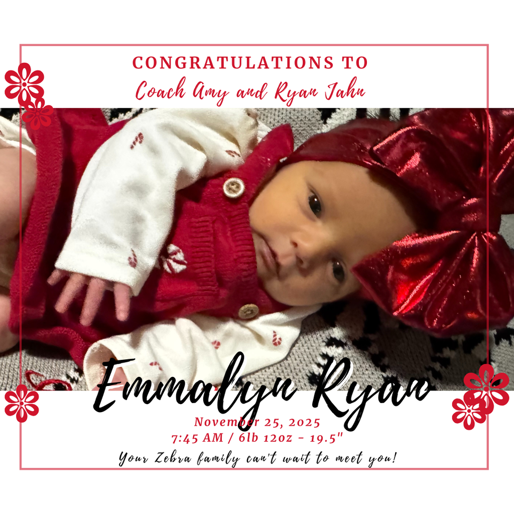 baby in big red bow on a blanket