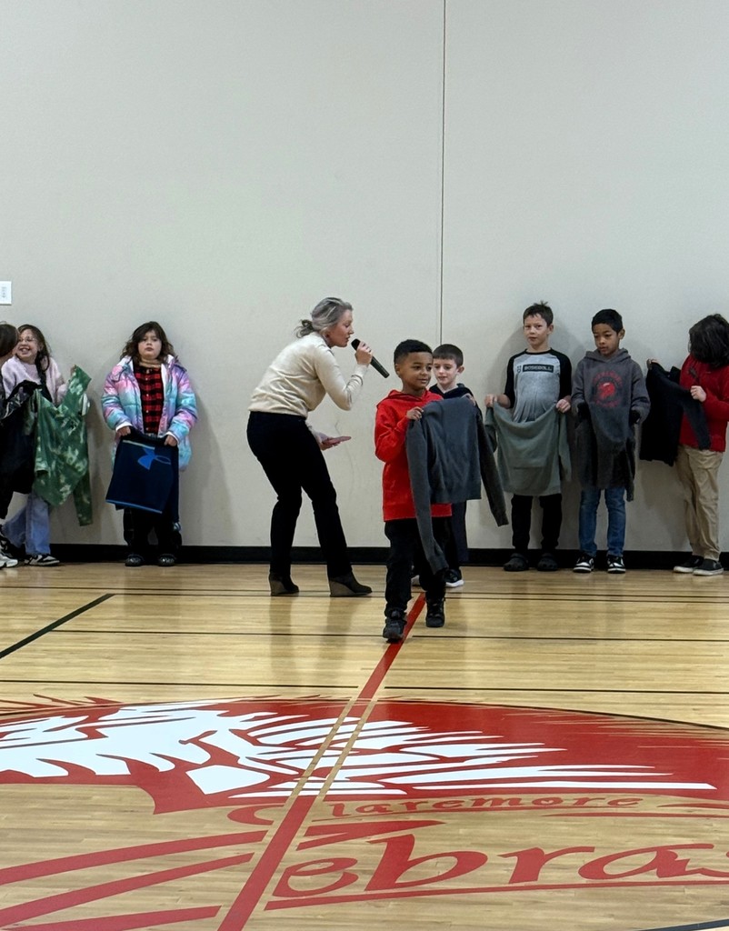 student showing off lost and found items