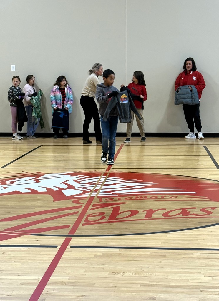 student showing off lost and found items