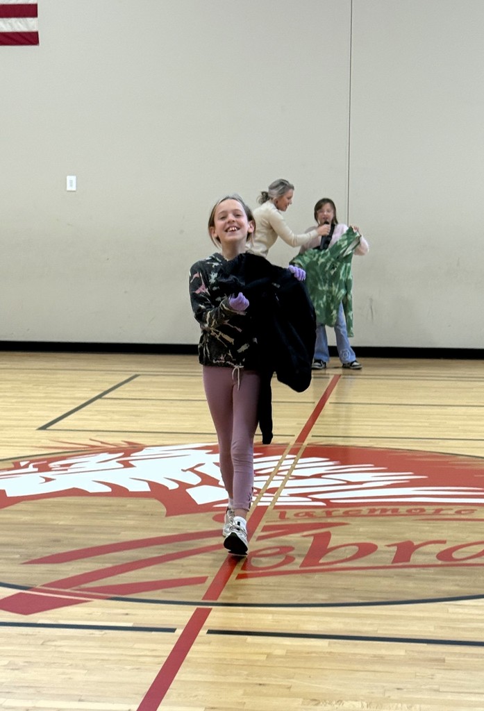 student showing off lost and found items