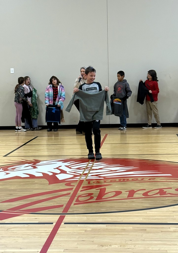 student showing off lost and found items