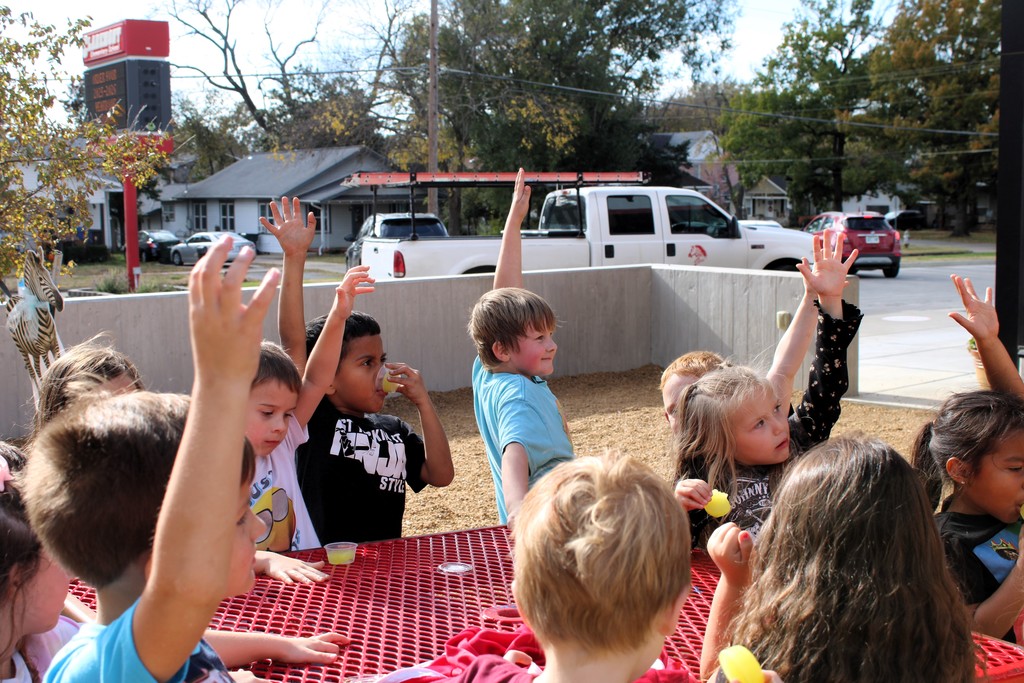 students raising hands