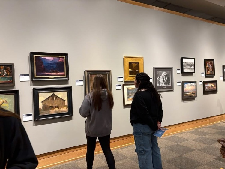 two students looking at art