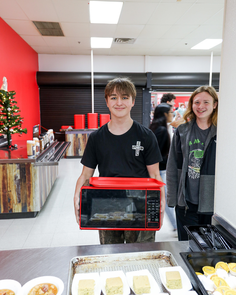 High school student with a microwave for a backpack.