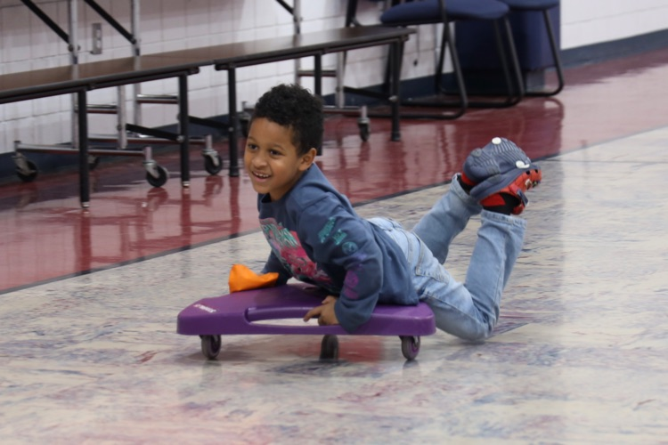Little boy riding a scooter