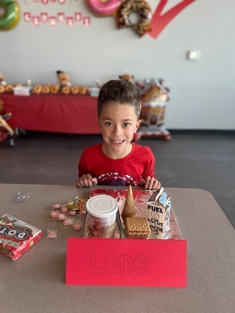 students and families making gingerbread houses