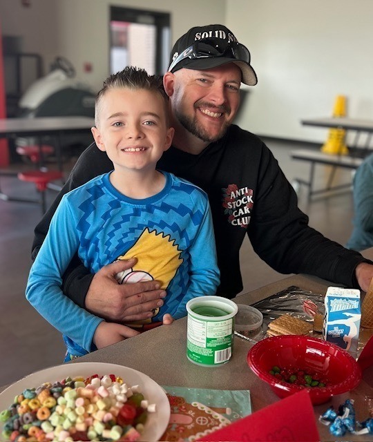 students and families making gingerbread houses