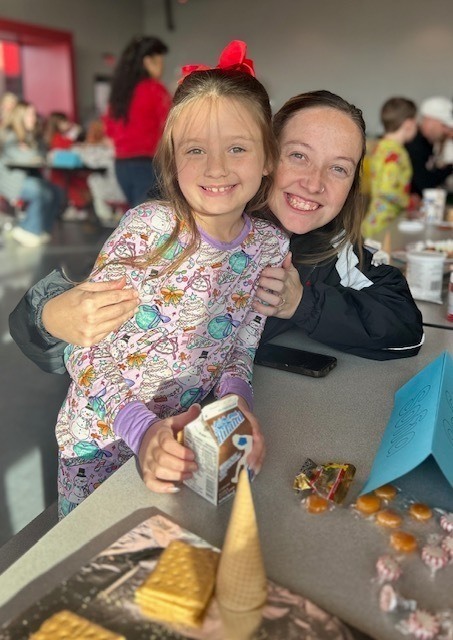 students and families making gingerbread houses