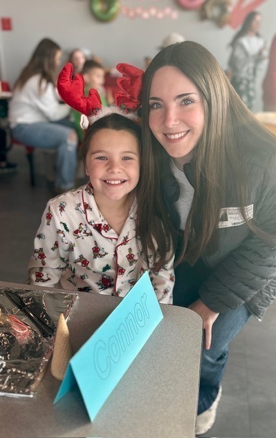 students and families making gingerbread houses