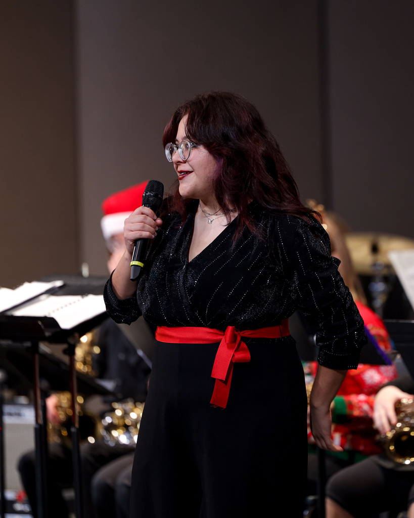 Student announcing the next song at the Band Winter Concert.