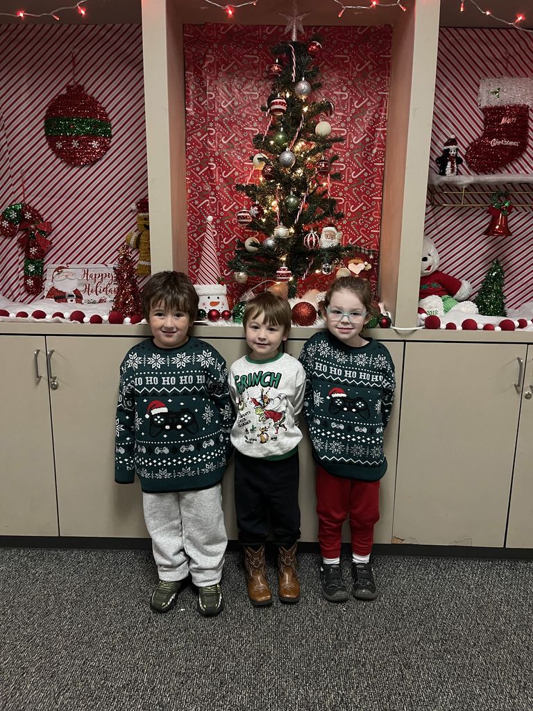 students wearing Christmas sweaters