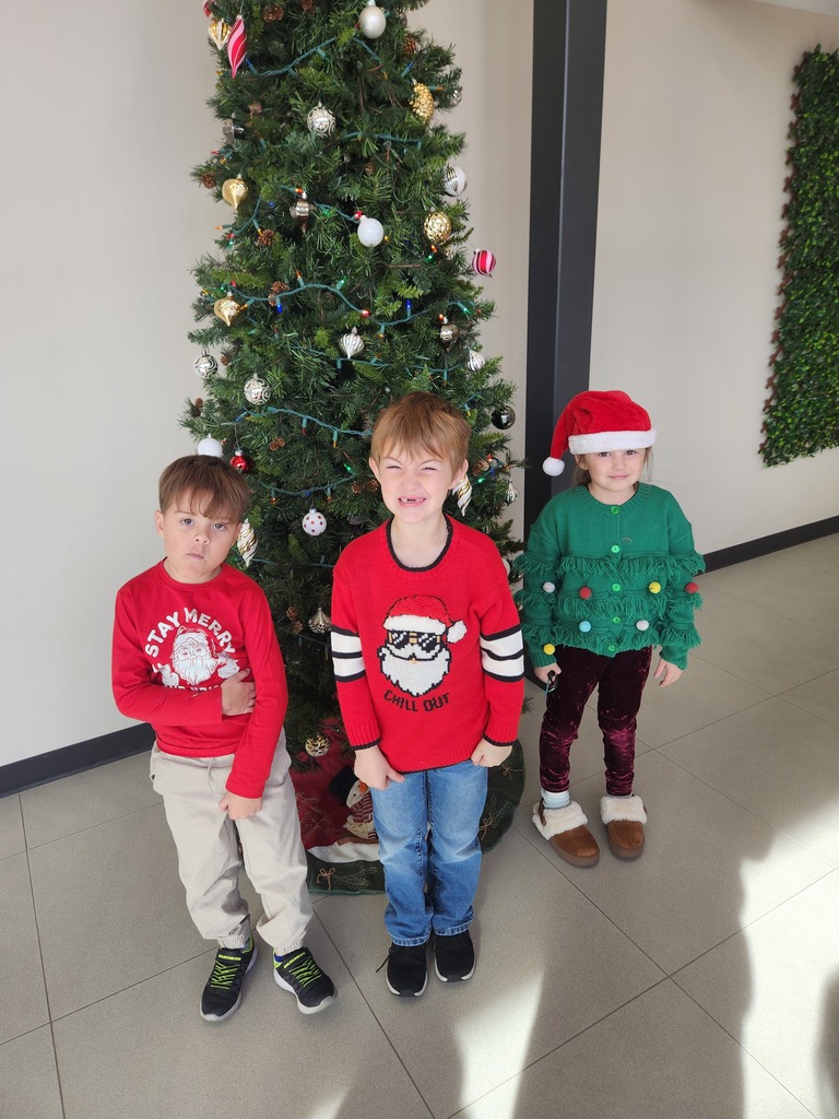 students wearing Christmas sweaters