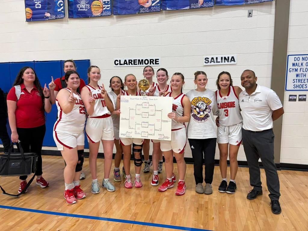 Varsity Girls Basketball Team with championship trophy.