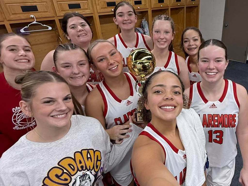 Varsity Girls Basketball Team with championship trophy.