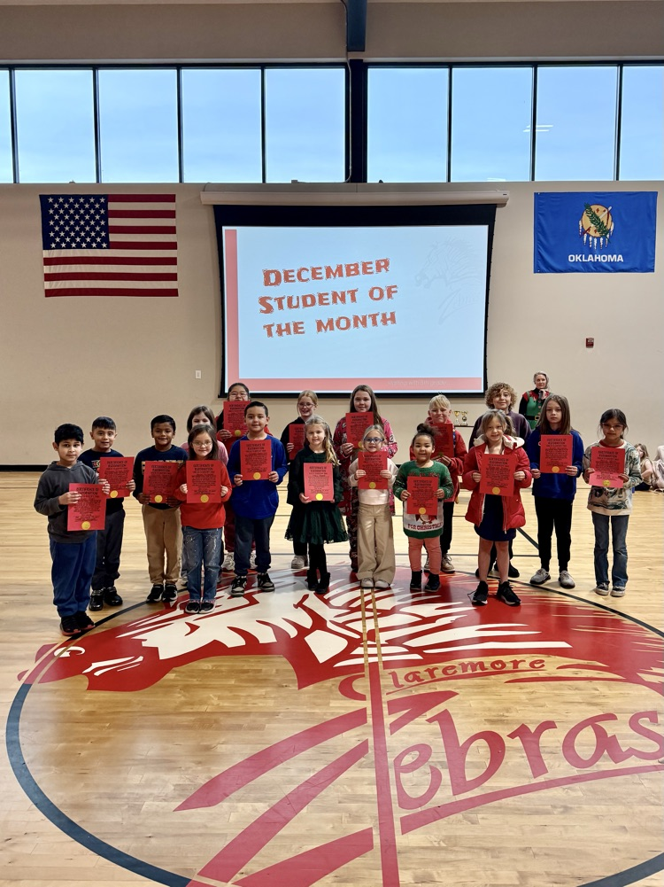 students holding a student of the month sign