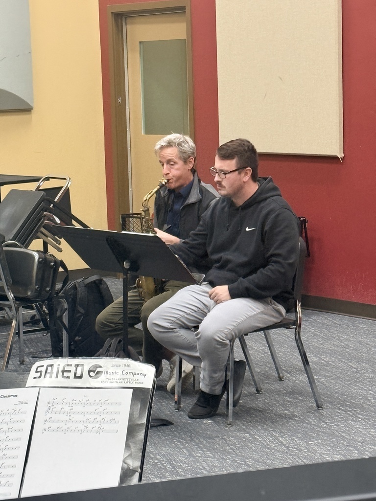 Dr. Tommy Poole playing his saxophone for the class