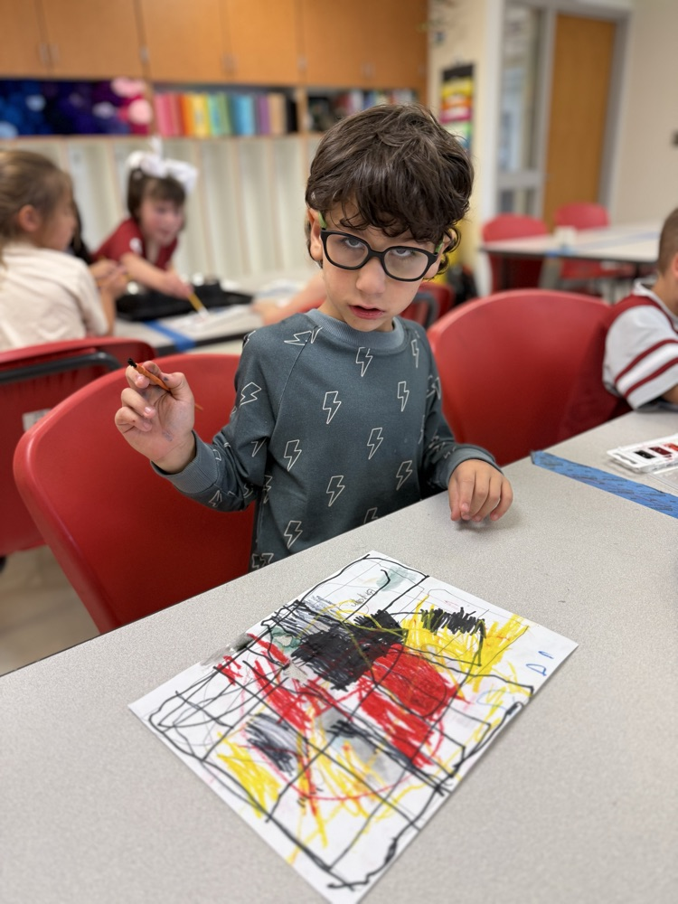 Student painting in art using primary colors