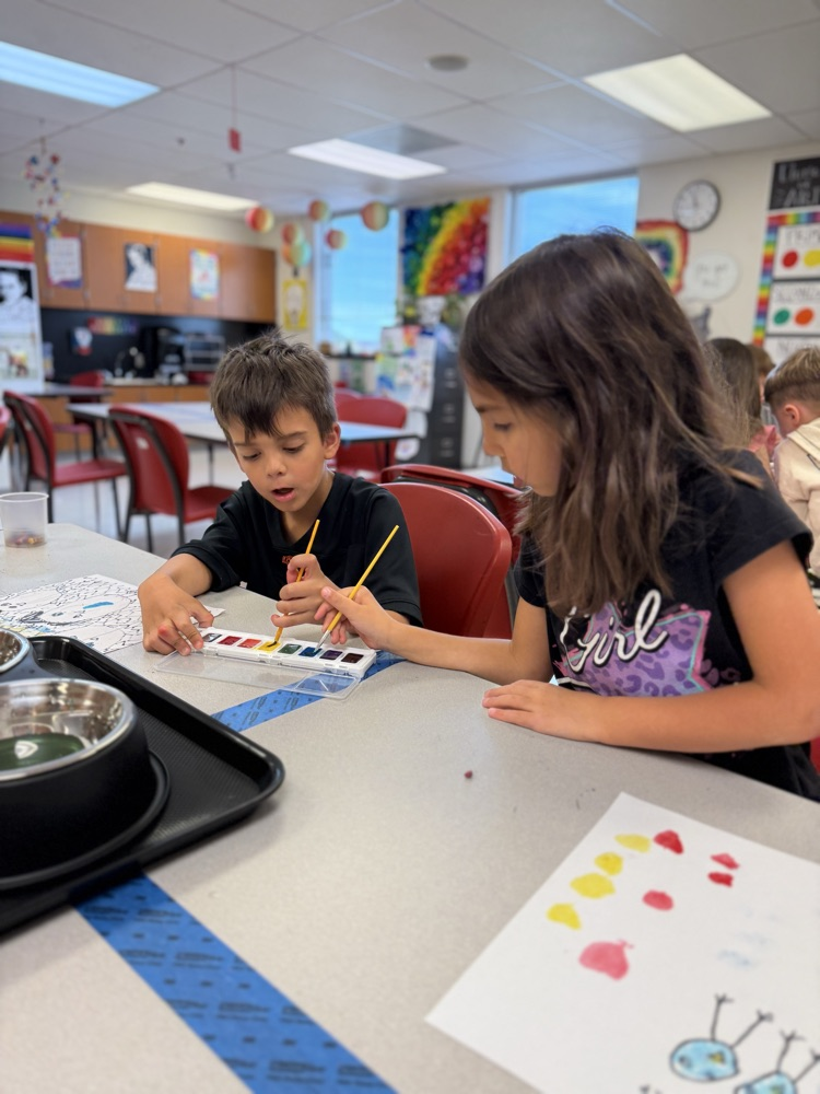 Students painting together in art class