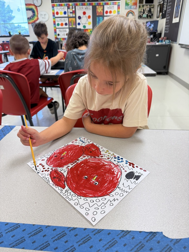 Student painting in art class