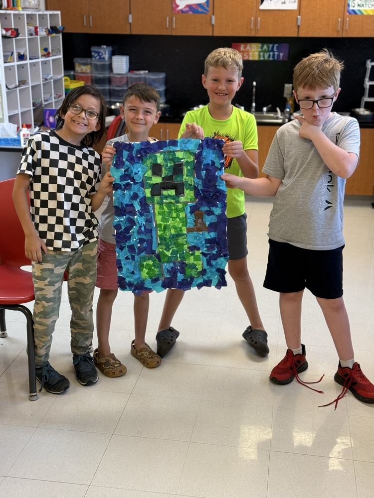 Students smiling with their art work