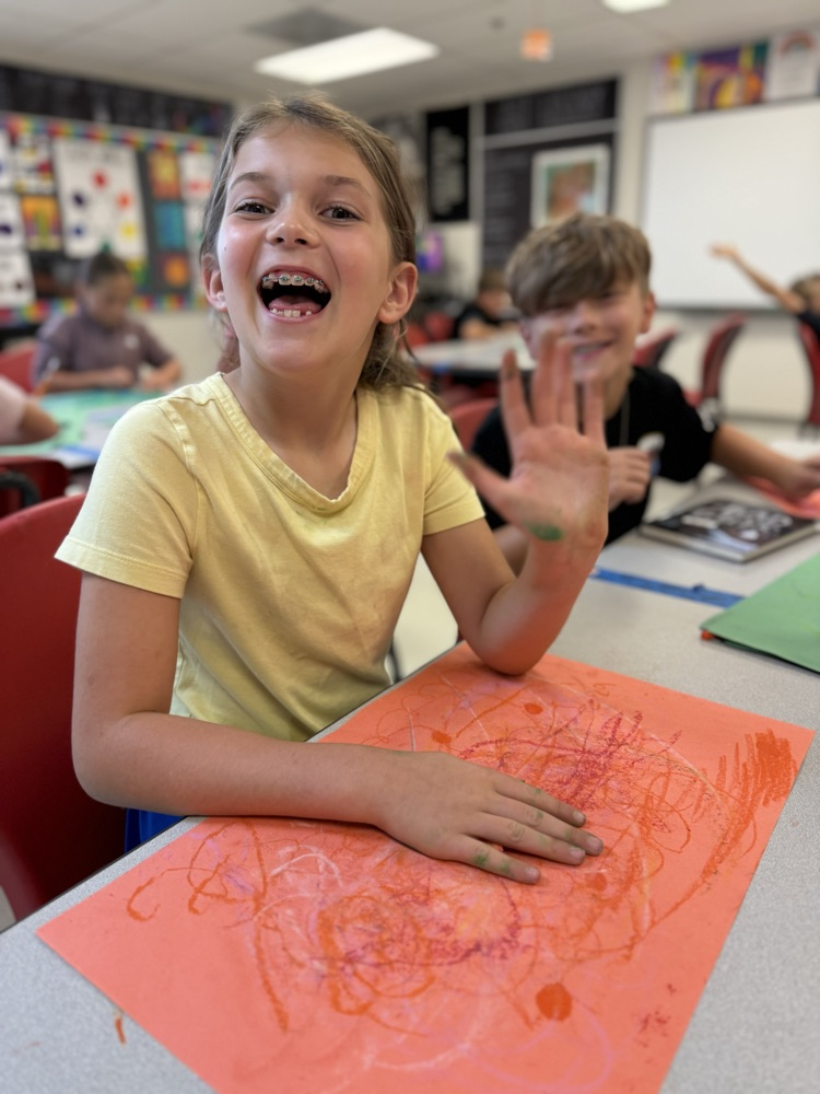 Student smiling and happy to be in art