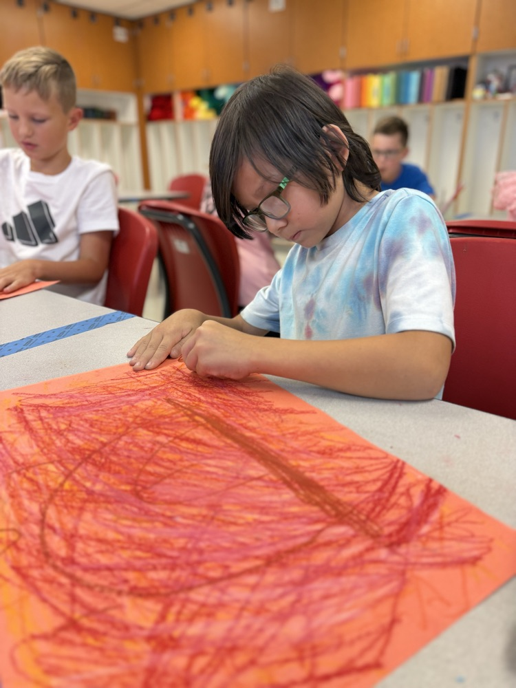 Student coloring in art