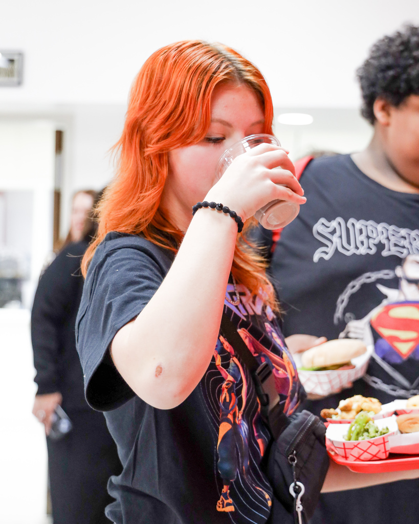 High school student tasting chocolate milk from the new milk delivery system. 