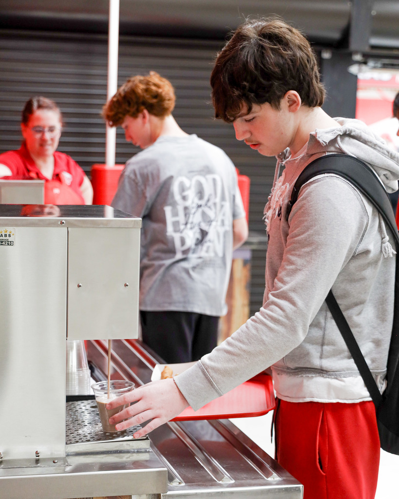 High school student trying out new milk delivery system.