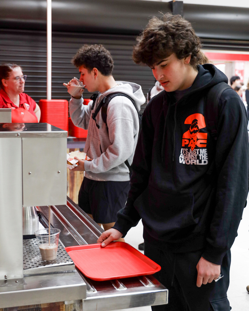 High school student trying out new milk delivery system.