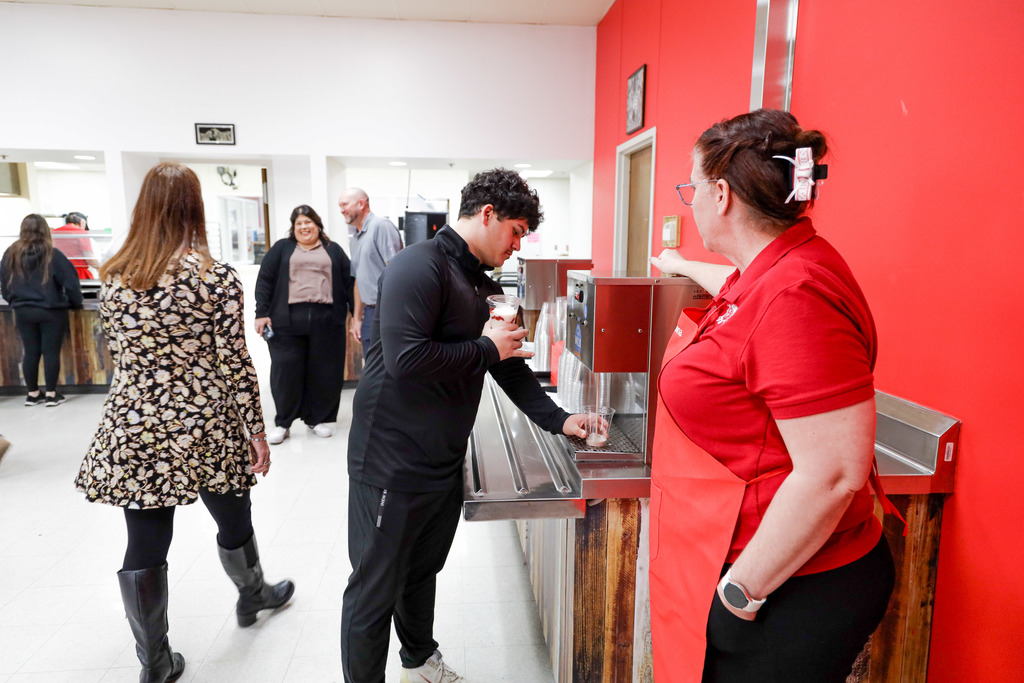 High school student trying out new milk delivery system.