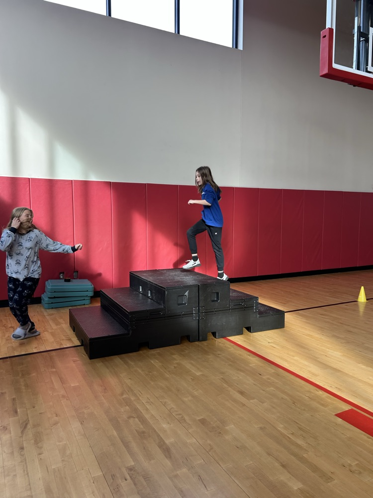 students playing at an obstacle course 
